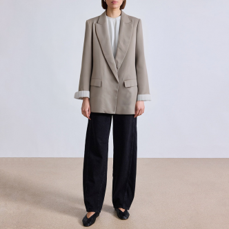 Women's suit jacket with padded shoulders and rolled sleeves