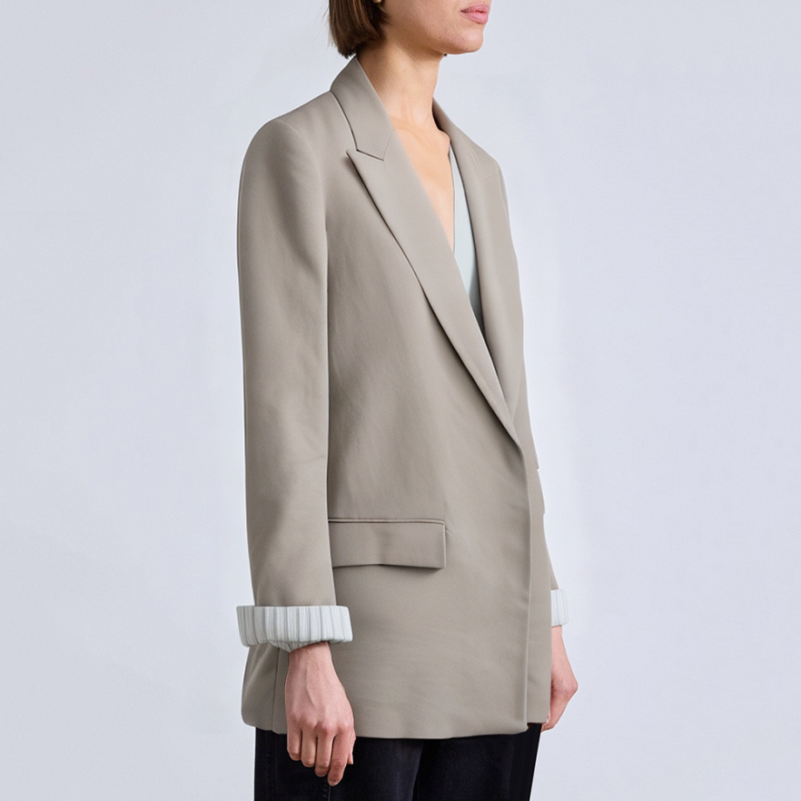 Women's suit jacket with padded shoulders and rolled sleeves